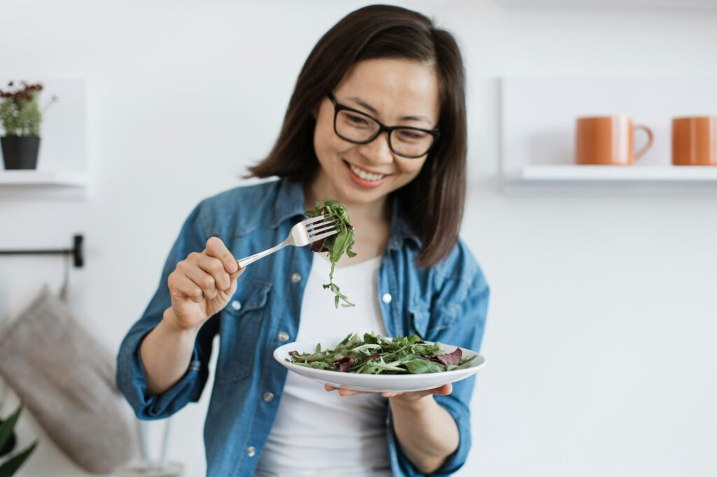 Female adult eating balanced diet in modern apartment