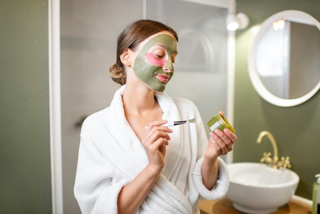 Woman with facial mask and patches in the bathroom
