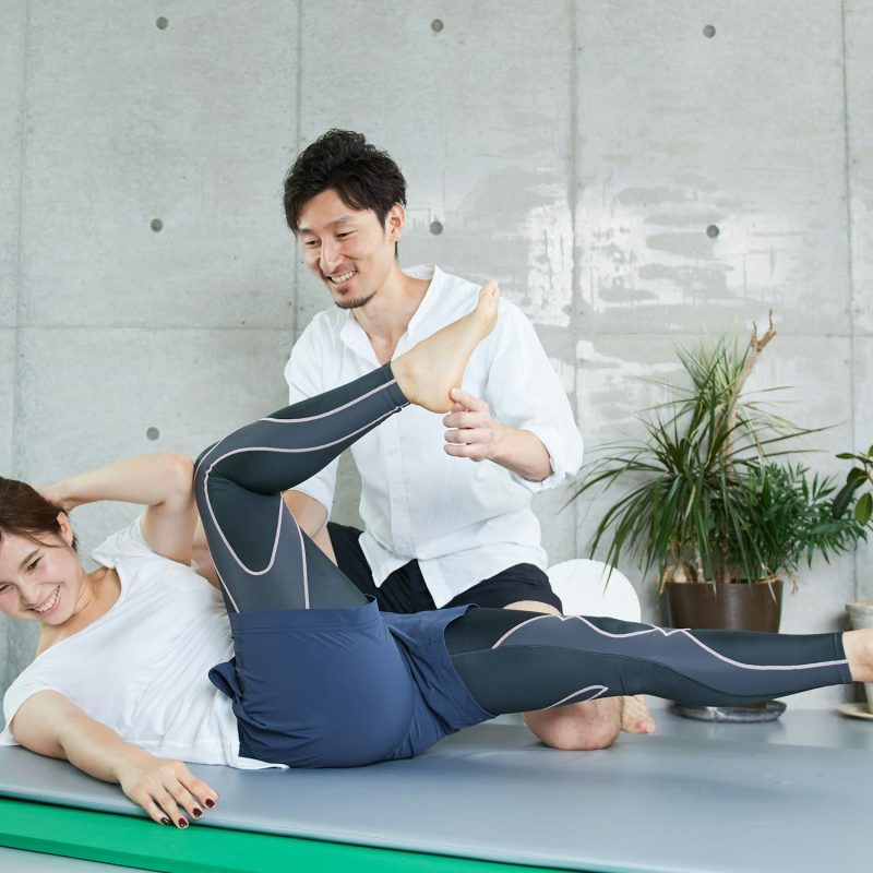 A woman receiving guidance for abdominal muscle training