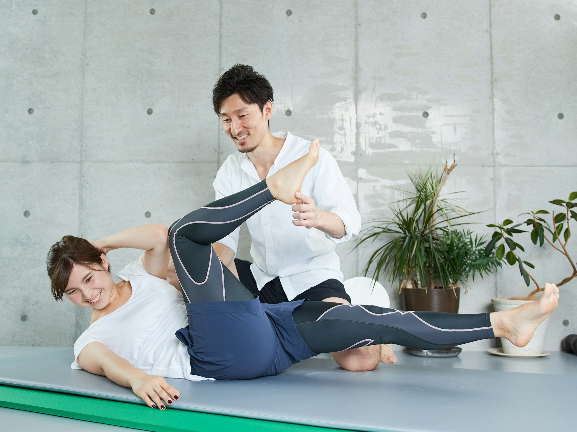 A woman receiving guidance for abdominal muscle training