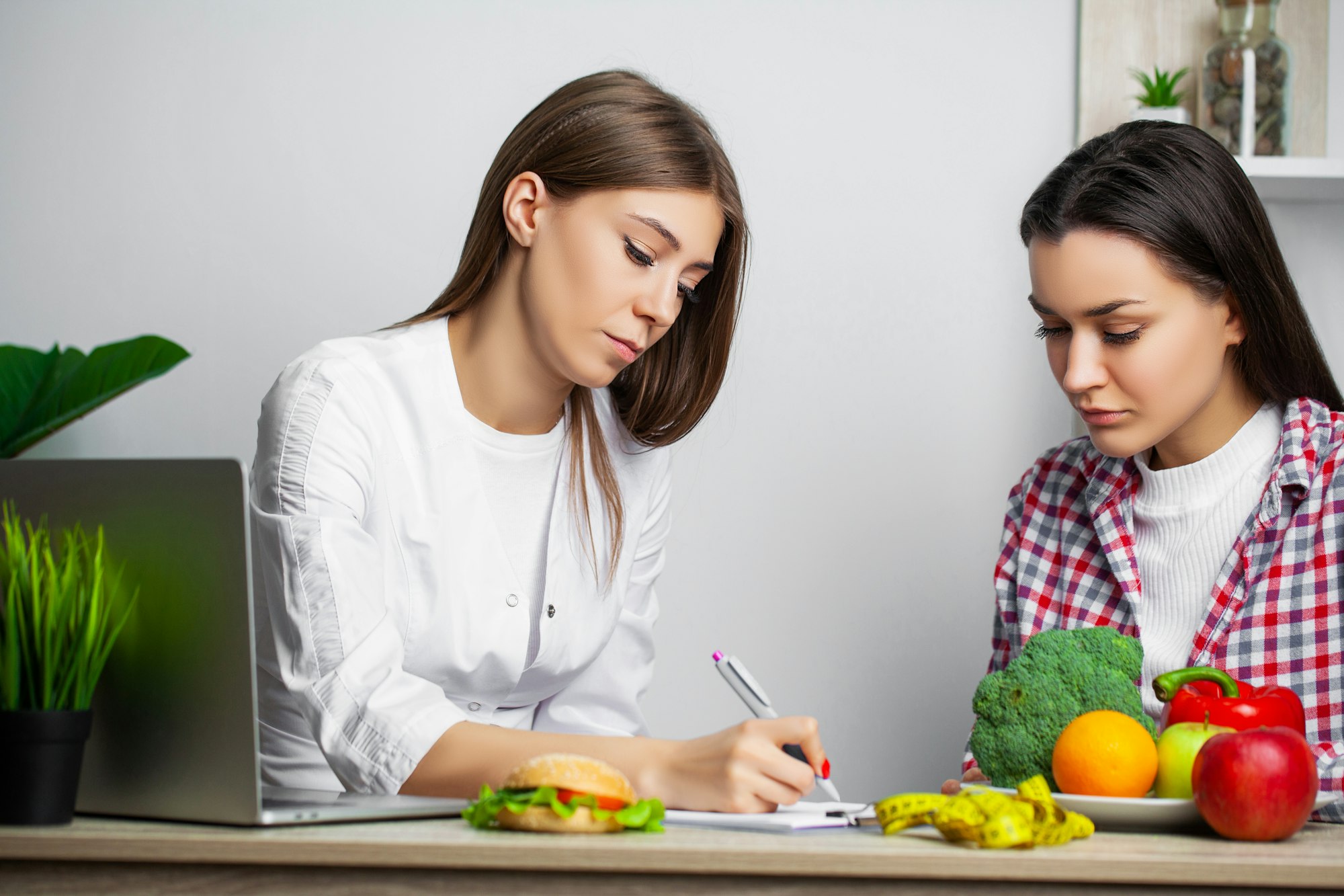 Young woman visiting nutritionist in weight loss clinic